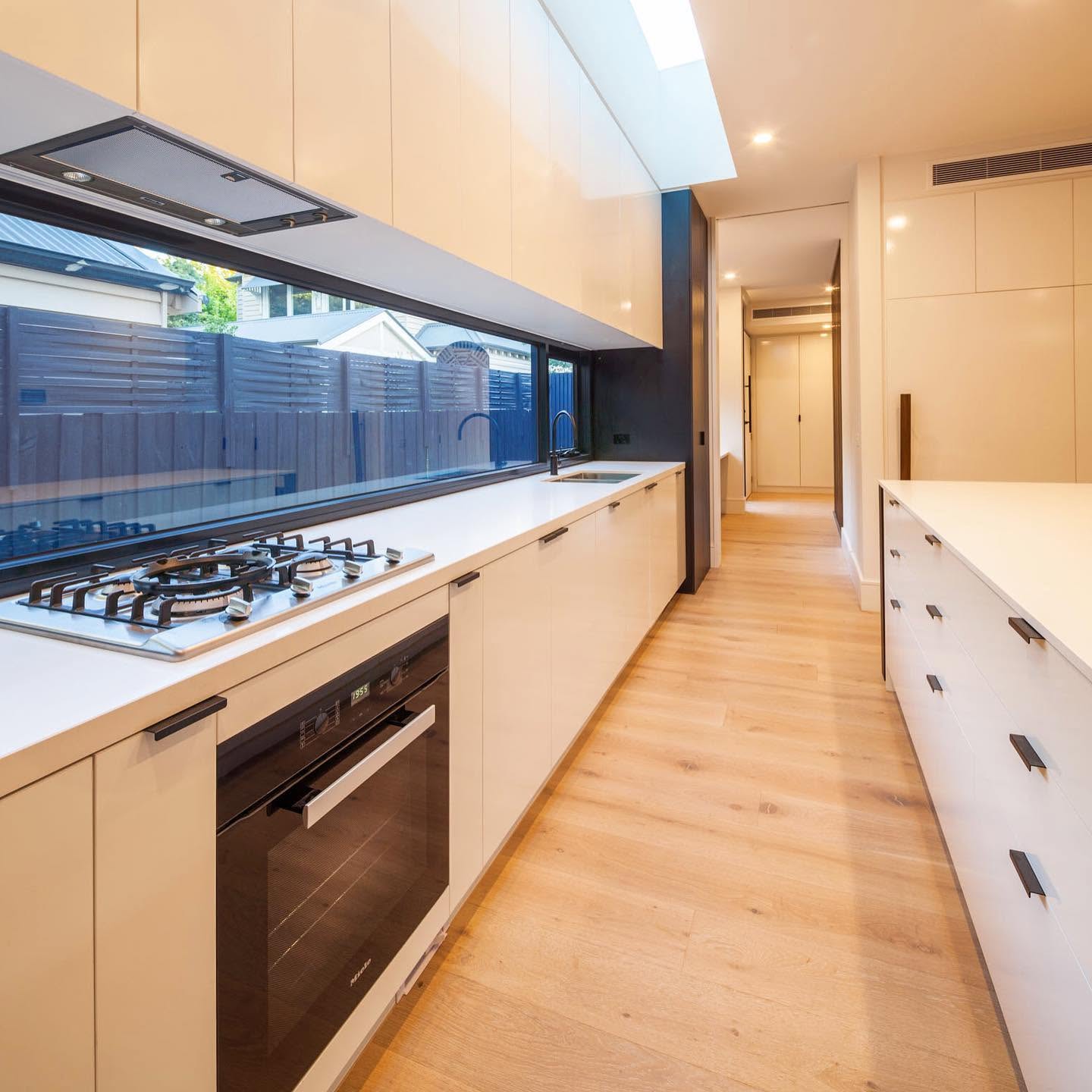 Light oak boards through a galley kitchen