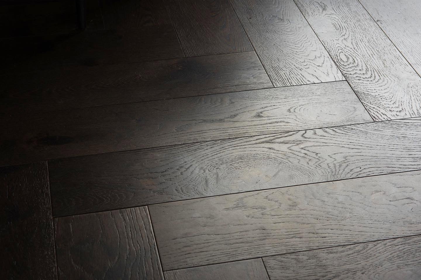 Close detail of a dark wide board oak floor